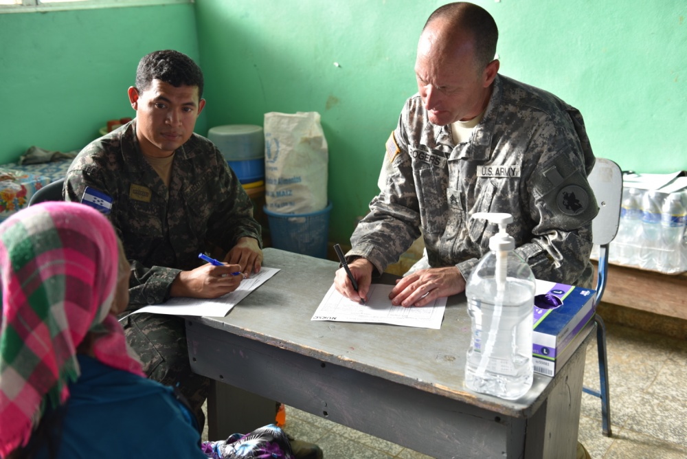 Honduran Army 1st Lt. Wilmer Perdomo works as an interpreter for U.S. Army Sgt. 1st Class Bill Rogers