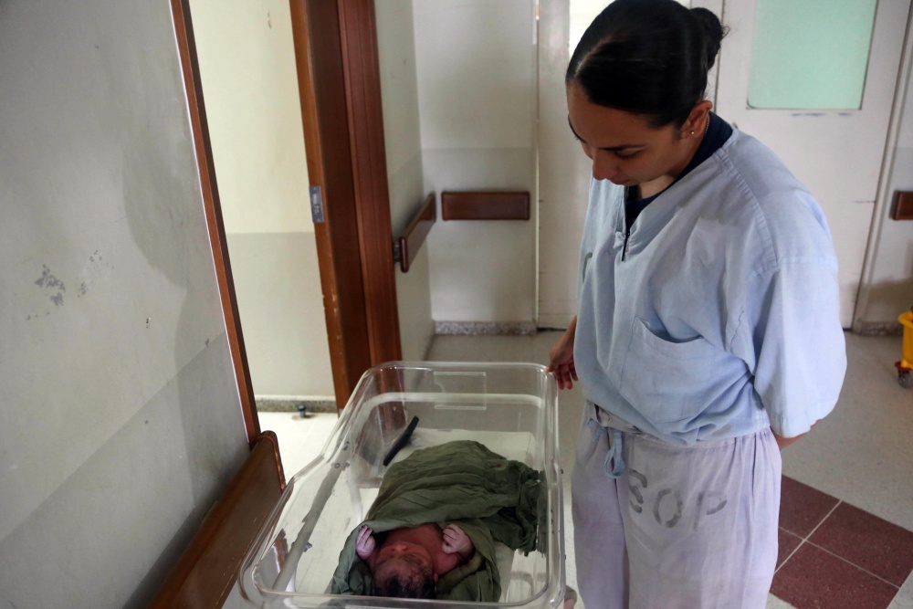 U.S. Navy Lt. Juliana Gutierrez watches a newborn baby at Hospital Nacional de la Amistad Japón-Guatemala