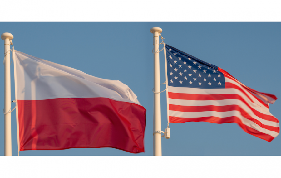 The flags of Poland and the United States flying next to each other.