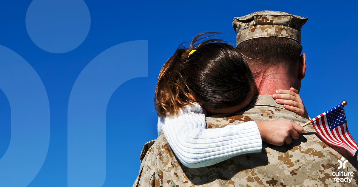 Image of a young girl hugging a servicemember.