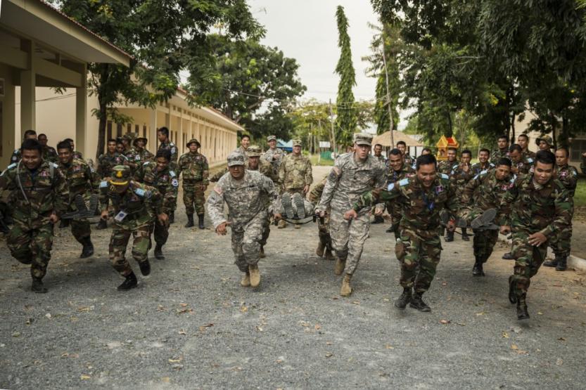 Members of the Idaho National Guard and the Royal Cambodian Armed Forces participate in a stretcher race in Cambodia
