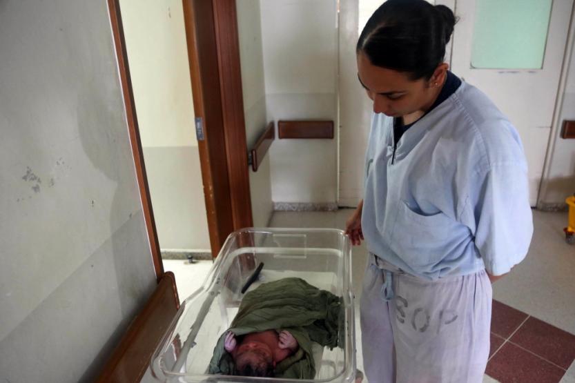 U.S. Navy Lt. Juliana Gutierrez watches a newborn baby at Hospital Nacional de la Amistad Japón-Guatemala