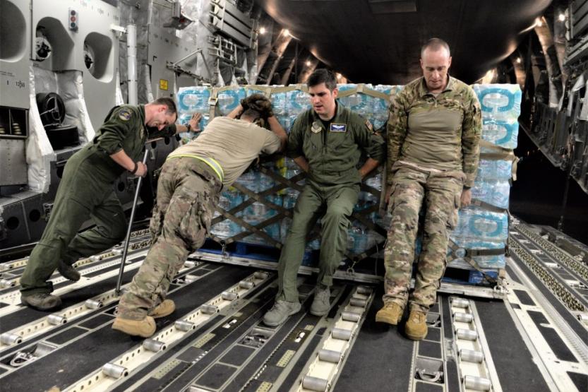 Airmen unload food and water from a C-17 Globemaster III to be distributed to hurricane survivors at San Juan Luis Muñoz Marín Airport in San Juan, Puerto Rico, on Sept. 30, 2017.