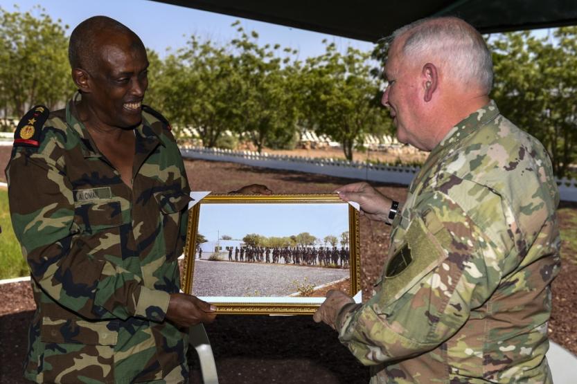 Djibouti Armed Forces Lt. Col. A. Omar presents a gift to U.S. Army National Guard Brig. Gen. Benjamin Adams III, Kentucky National Guard deputy adjutant general, during a State Partnership Program visit to the FAD military training center at Holhol, Djibouti.