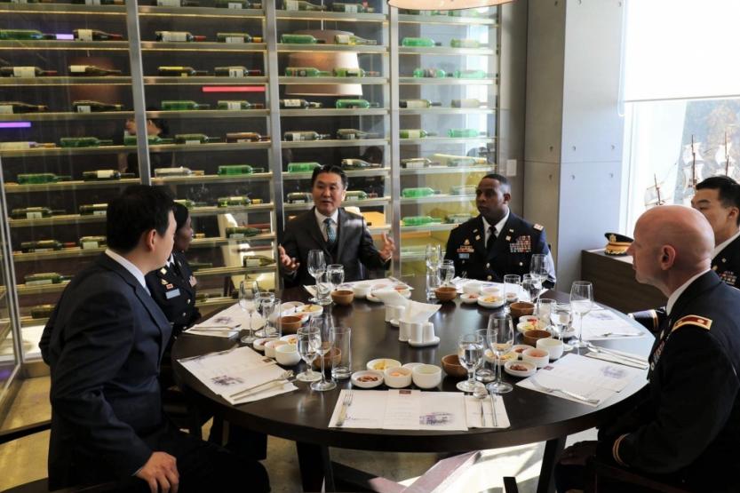 Officers assigned to the 25th Transportation Battalion, Materiel Support Command Korea, 19th Expeditionary Sustainment Command, are seated at the 42nd Street Restaurant, where students majoring in hotel culinary arts at Daekyeung University cook and serve them lunch dishes as a part of the university’s Good Neighbor Program, Daekyeung University, Gyeongsan, Korea.