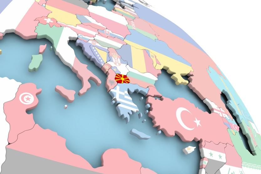 Rendering of globe, close-up over southern Europe. Each country is represented by its flag. The flag/country of Macedonia is brighter than the others.