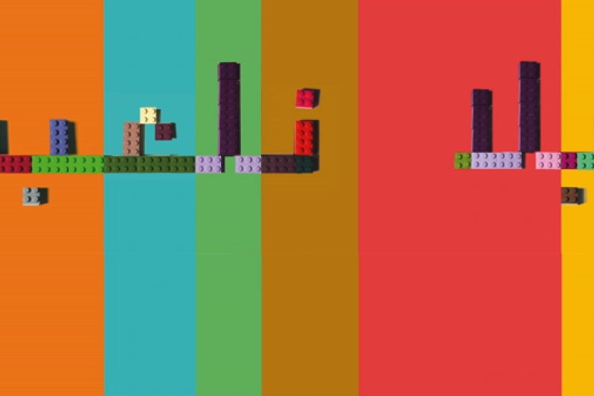 Colorful image of the words "let's play" in the Arabic script, formed by LEGO building blogs