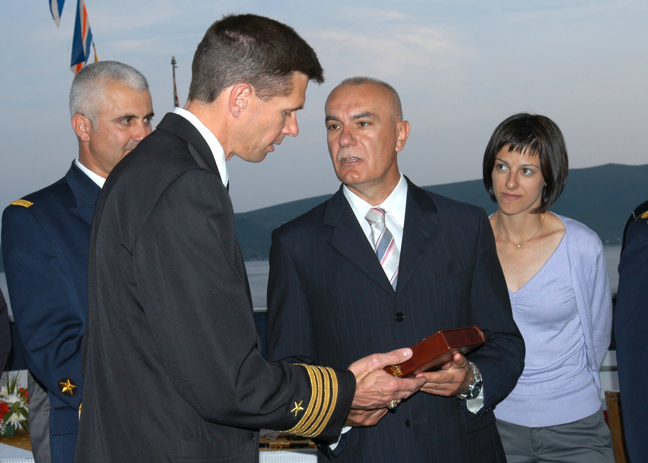 Minister of Defense Boro Vucinic and USS Emory S. Land (AS_39) Commanding Officer, Capt. Jeffrey M. Hughes, exchange gifts during a reception on board the Emory S. Land to celebrate Montenegro's first year of independence.