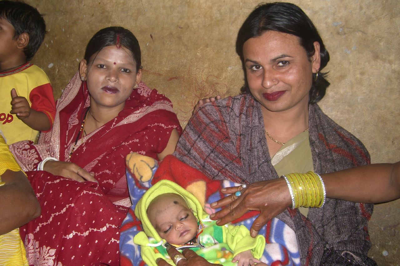 Two Hindu women, one of them holding a baby