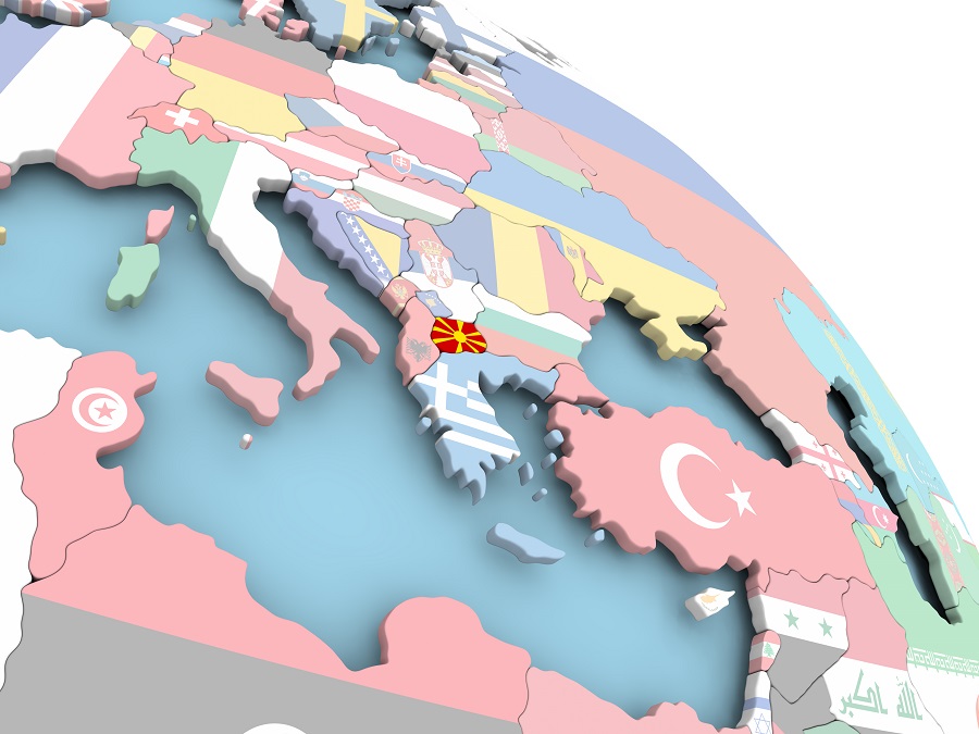 Rendering of globe, close-up over southern Europe. Each country is represented by its flag. The flag/country of Macedonia is brighter than the others.