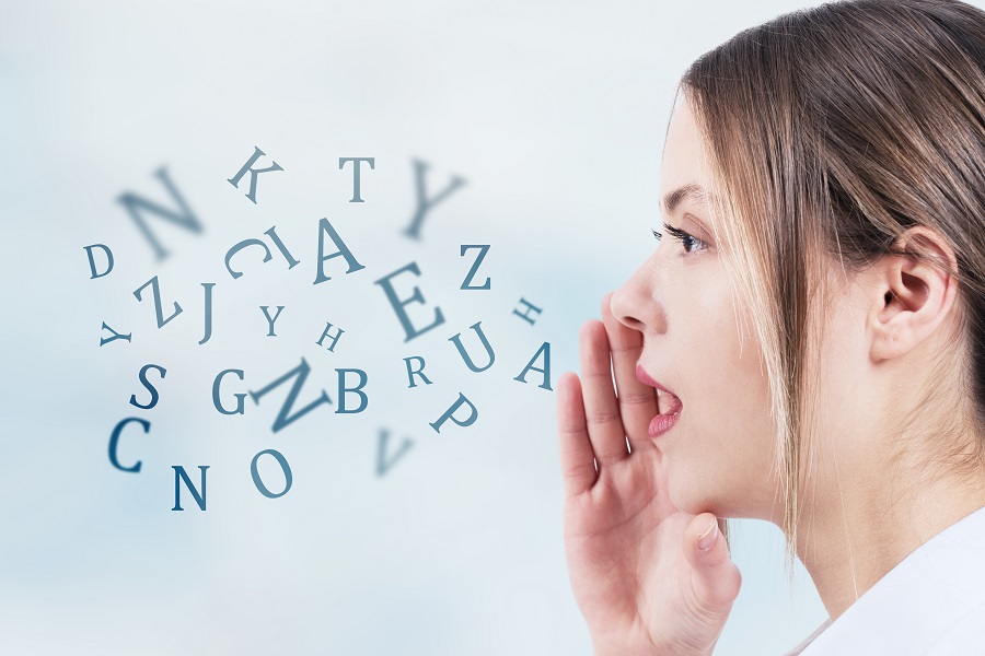 Image of woman speaking, with letters coming out of her mouth