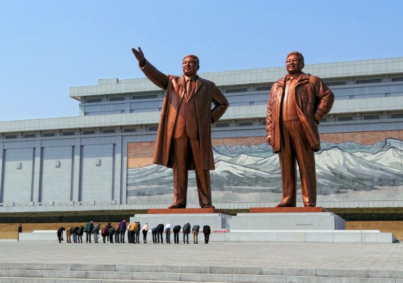 Visitors bowing in a show of respect for North Korean leaders Kim Il-sung and Kim Jong-il on Mansudae (Mansu Hill) in Pyongyang, North Korea.