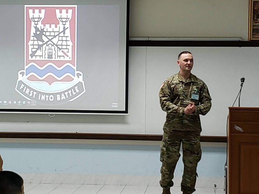 Maj. Mike Boitano stands in front of a presentation in Thailand