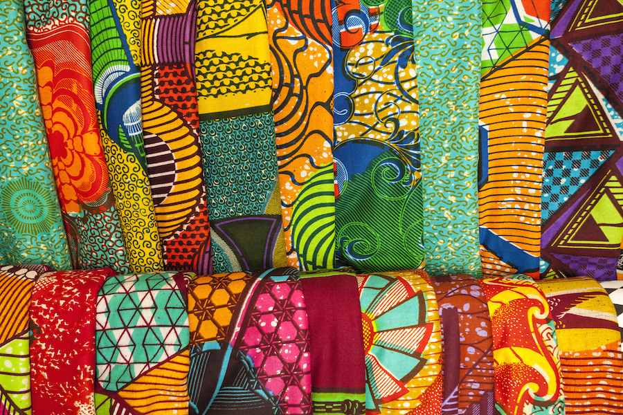 A close of shot of multiple African traditional fabrics in a shop in Ghana, West Africa.