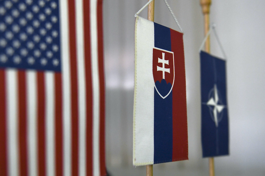 The U.S., Slovak, and NATO flags displayed together.