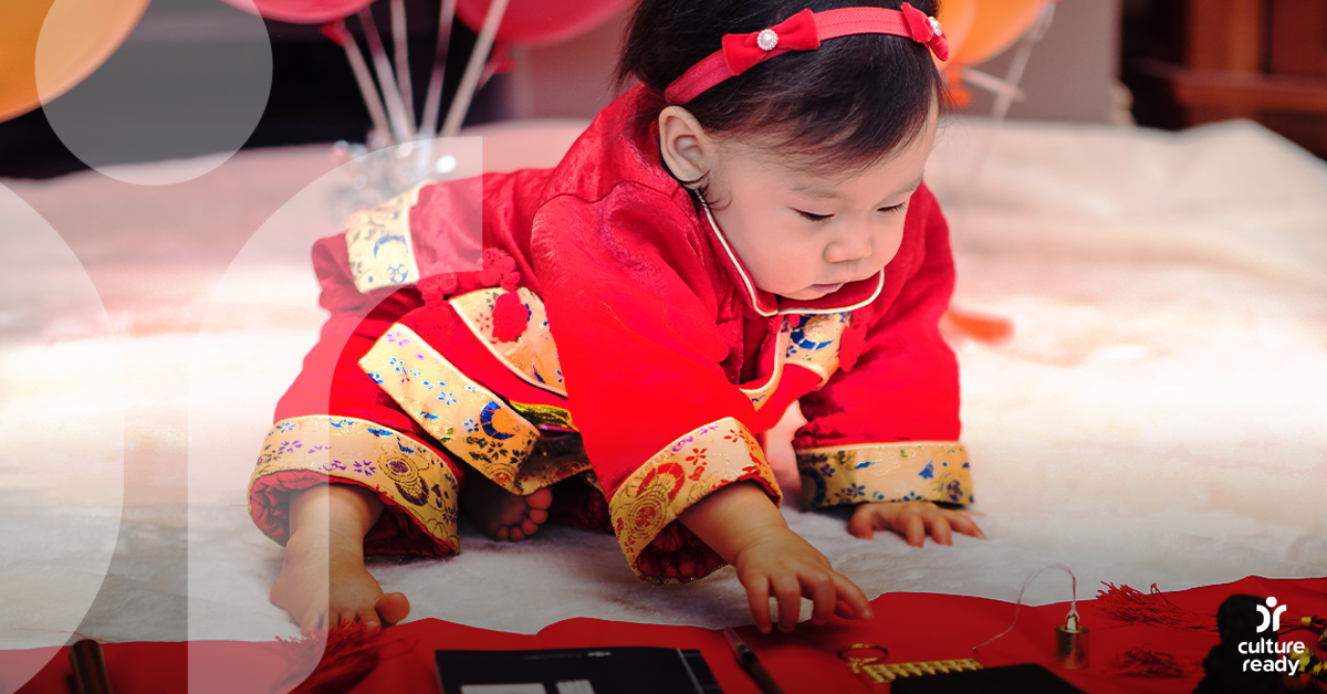 A baby girl dressed in red celebrating her second birthday