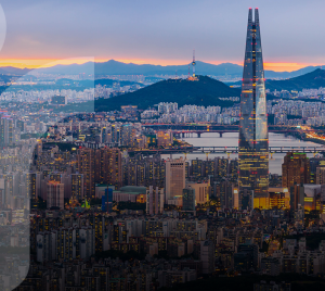 A cityscape of Seoul, South Korea, at dawn with mountains in the background