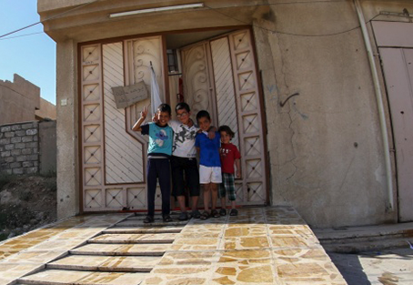 Four kids in a doorway
