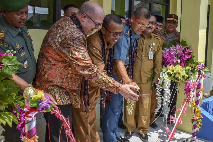 Members of the US Navy and Indonesian Marines cut the ribbon as part of a ceremony for the opening of a school