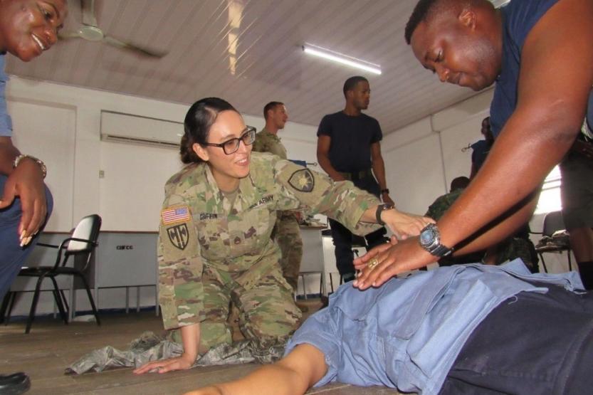 A Florida Army Guard medic with the 256th Medical Company Area Support (MCAS), shows the procedures to perform first aid for an open chest wound to members of Guyana’s defense force and coast guard.