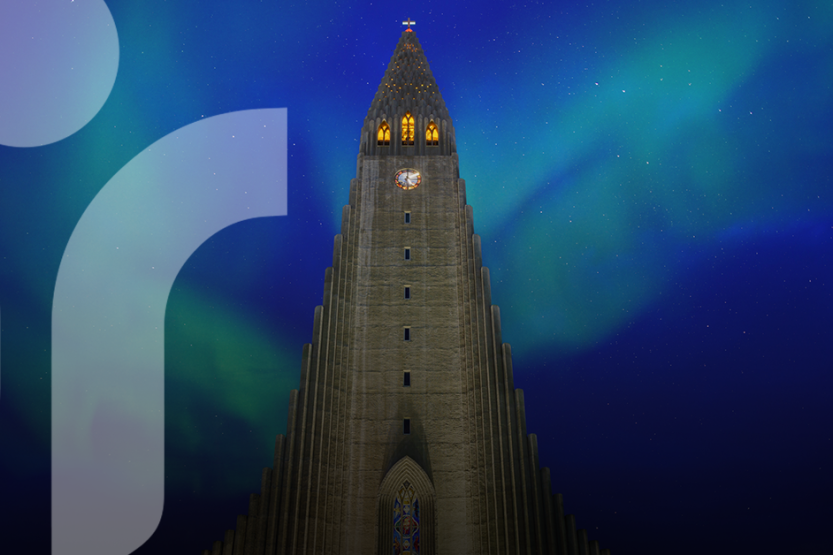 A picture of Hallgrímskirkja Church with Northern Lights in the sky behind it.